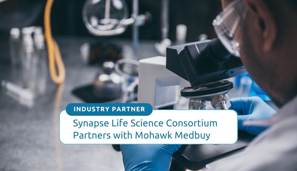 Image of a lab researcher in the background.